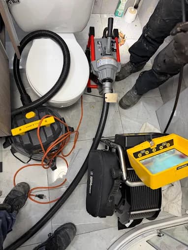 High-pressure cleaning equipment set up in a bathroom